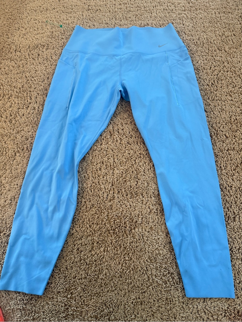 Nike Light Blue Women's High-Waist Performance Leggings with raw hem.